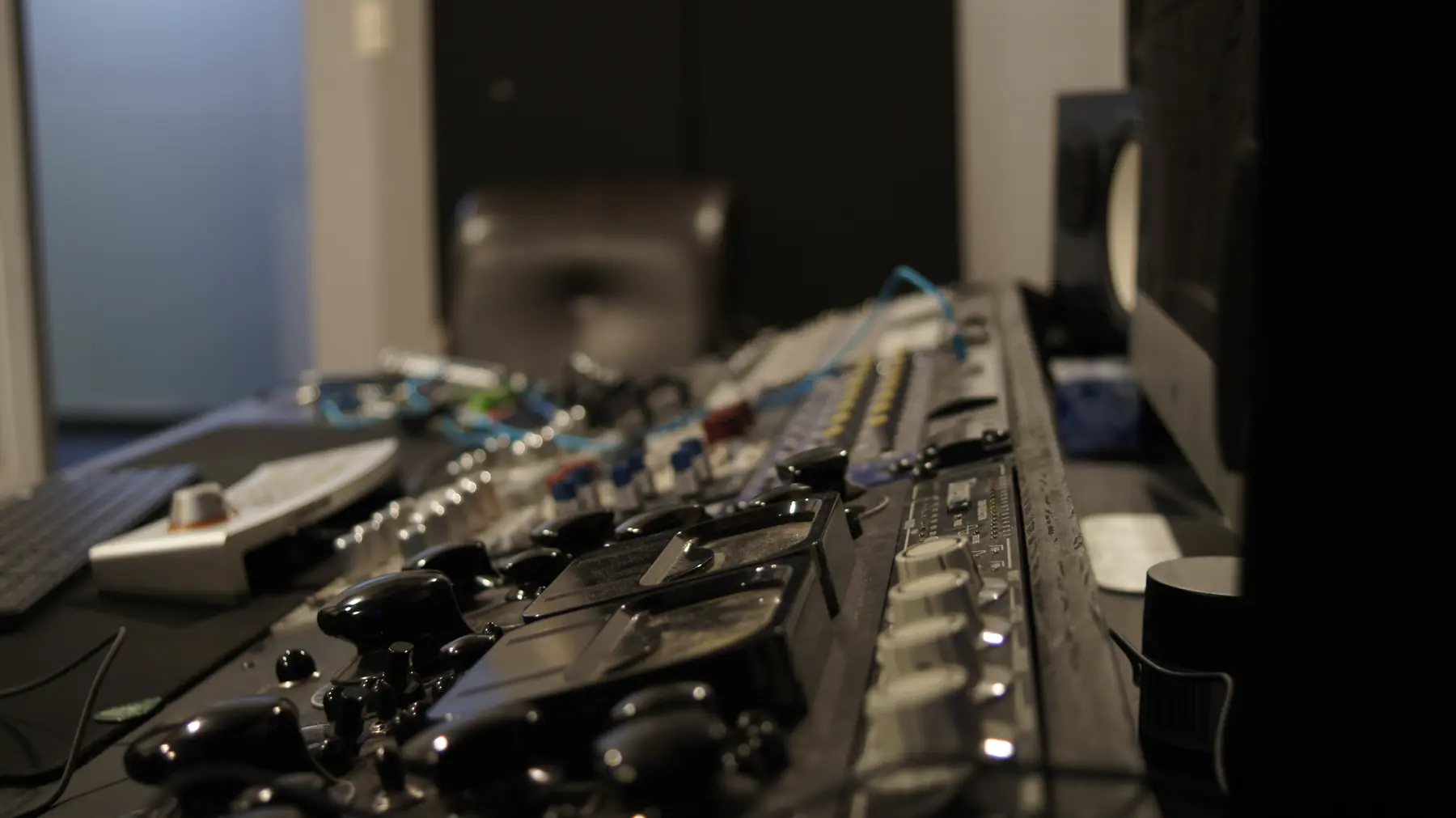 Close-up along the analog console in Studio A, showing its controls and channel strips